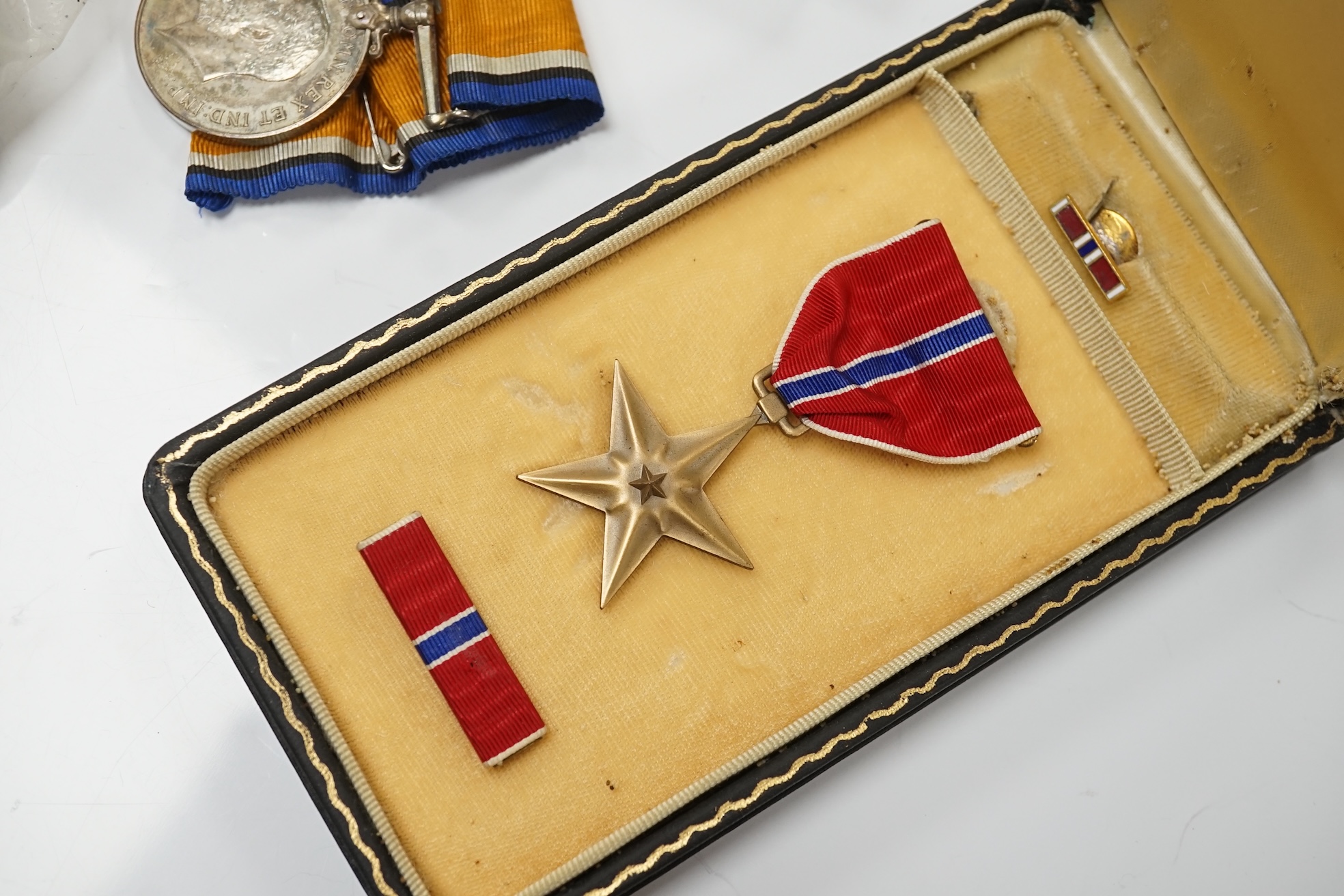 A collection of military interest medals and cloth badges to include a 1914-1918 medal awarded to Lieut. W. C. Griffith and an unnamed 1910-1935 medal. Condition - varies